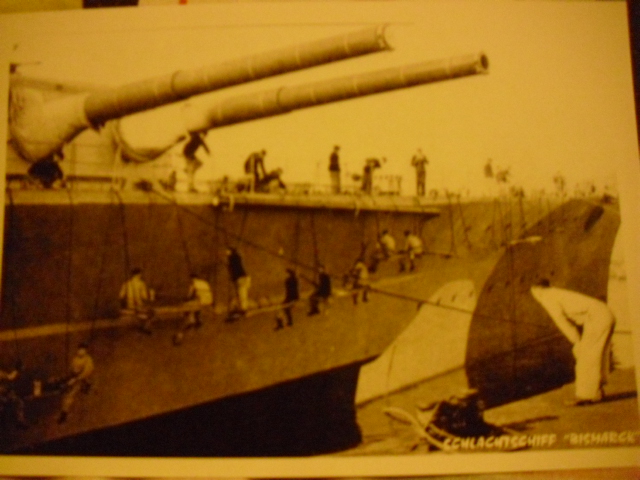 The Bismarck's camouflage is touched up at Scheerhafen, Kiel in March 1941.